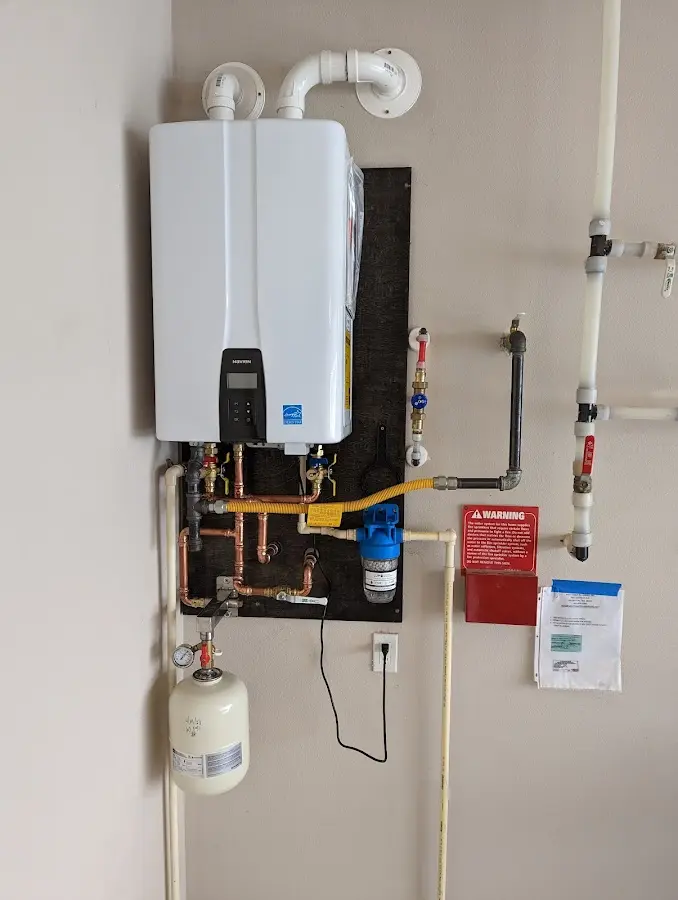 Professional plumber installing copper piping in a Wakefield home